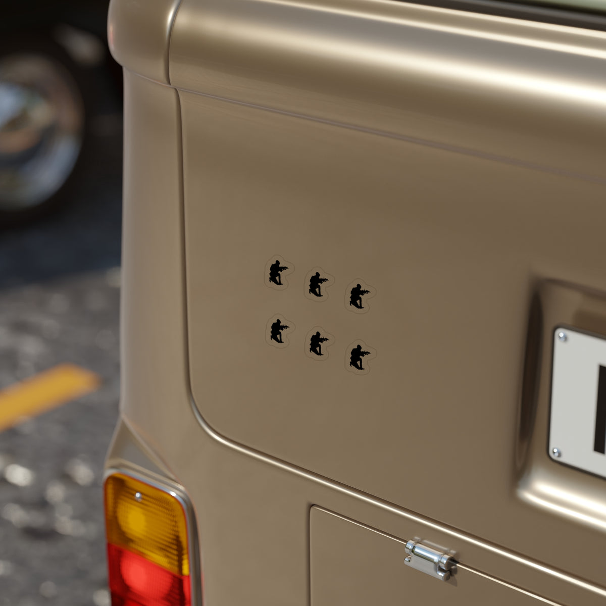 Beige vehicle with a sticker on the back reading 'I'm only here for the snacks' on a blurred street background.